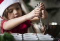 Little girl making chocolate cupcakes