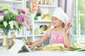 little girl making dinner on kitchen table at home Royalty Free Stock Photo