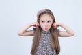 Little girl is making faces. Funny expressions. Having fun. Preschooler in dress on white background. Royalty Free Stock Photo