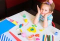 Little girl making flower with center earth planet shape from plasticine, Home Education game with clay. Early development and