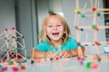 Little girl making geometric shapes, engineering and STEM Royalty Free Stock Photo