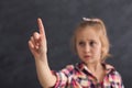 Little girl making gesture at black background Royalty Free Stock Photo