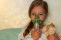 Little girl making inhalation with nebulizer home. Sick allergic kid asthma inhaler steam cough. Child allergy rhinitis Royalty Free Stock Photo