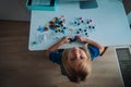 Little girl making model of a molecule, kid learning chemistry