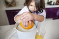 Little girl making orange juice Royalty Free Stock Photo