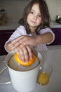 Little girl making orange juice Royalty Free Stock Photo