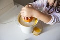 Little girl making orange juice Royalty Free Stock Photo