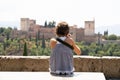 Little girl making photo with DSLR camera to the Alhambra.