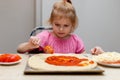 Little girl making pizza. Small child cooking meal in the kitchen at home. Royalty Free Stock Photo