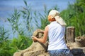 Little girl making a sand sculpture on a beach of a river