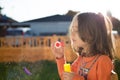 Little girl making soap bubbles