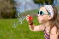 A little girl making soap bubbles Royalty Free Stock Photo