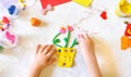 Little girl making vase with flowers from colorful clay, dough, plasticine, Home Education game with clay. Early development Royalty Free Stock Photo