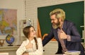 Little girl and man against blackboard. Knowledge day. Child with teacher in classroom. Teachers day concept. Consulting Royalty Free Stock Photo