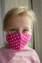 Little girl in a mask for protection against pm2.5 and Covid-19 virus. Hand made mask for protection against