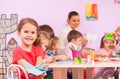 Little girl with mates in origami class Royalty Free Stock Photo