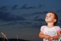 Little girl on meadow before sunset