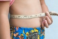 Little girl measuring her stomach Royalty Free Stock Photo