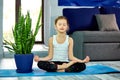 Little girl meditating in lotus pose with closed eyes Royalty Free Stock Photo