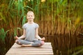 Little Girl meditating at sunrise on the beach