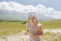 Little girl with melon slice in hand enjoying being on Alpine meadow Royalty Free Stock Photo