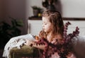 A little girl misses on the couch in the living room. Children`s emotions