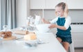 Little girl mixing a bowl of batter. Young child baking alone in the kitchen. Little girl sitting at her kitchen counter Royalty Free Stock Photo