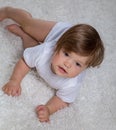 Little girl in model pose on the bedspread Royalty Free Stock Photo