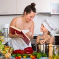 Little girl and mom with cookery book Royalty Free Stock Photo