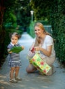 Little girl with mom holding present