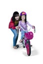 Little girl with mom learns to ride bicycle Royalty Free Stock Photo