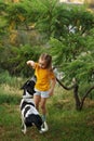 Little girl and mongrel dog outdoors