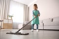 Little girl mopping floor in living room at home Royalty Free Stock Photo