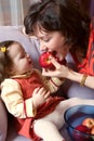 Little girl and mother with apples