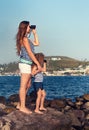 Little girl and mother looking far away with binoculars