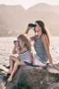 Little girl and mother looking far away with binoculars