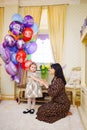 little girl and mum at home with balloons. Inflatable hero of Russian cartoon