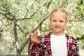 Little girl with nasal drops near blooming tree. Allergy concept Royalty Free Stock Photo