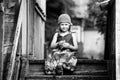 Little girl in national dress in the village. Black and white photography. Royalty Free Stock Photo