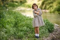 Little girl in nature stream wearing beautiful dress Royalty Free Stock Photo