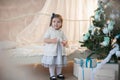 Little girl near Christmas tree with presents rejoices holiday, new year, decorations, gift, box, holiday, lifestyle Royalty Free Stock Photo