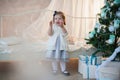 Little girl near Christmas tree with presents rejoices holiday, new year, decorations, gift, box, holiday, lifestyle Royalty Free Stock Photo