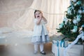 Little girl near Christmas tree with presents rejoices holiday, new year, decorations, gift, box, holiday, lifestyle Royalty Free Stock Photo