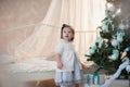 Little girl near Christmas tree with presents rejoices holiday, new year, decorations, gift, box, holiday, lifestyle Royalty Free Stock Photo