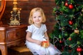 Little girl near festive christmas tree Royalty Free Stock Photo