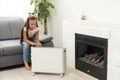 little girl near the heater. Energy crisis Royalty Free Stock Photo