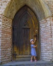 Little girl near the old fashioned door of the church