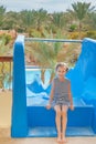Little girl near water park slides Royalty Free Stock Photo