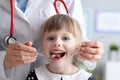 Little girl is not afraid to show teeth to dentist