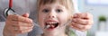 Little girl is not afraid to show teeth to dentist